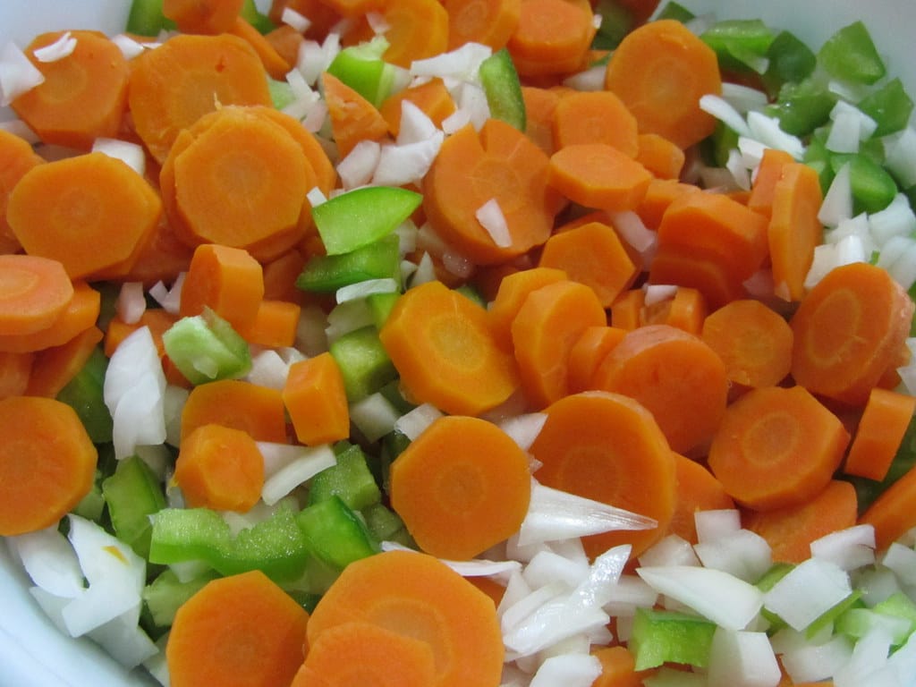 A bowl of chopped carrots, peppers, and onions waiting to be marinated