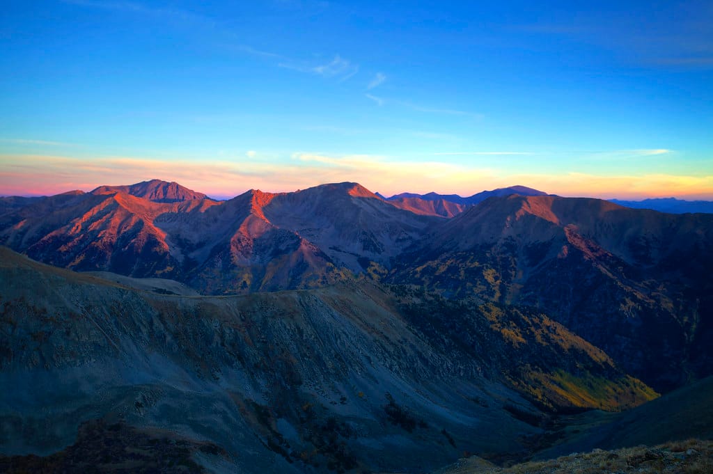 A mountain summit at sunrise — a new capability tier above the last