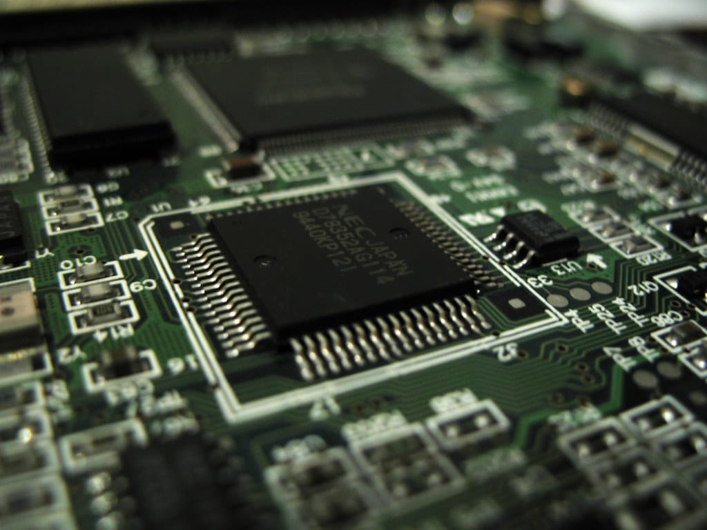 Macro photo of a microprocessor on a circuit board — small, capable compute