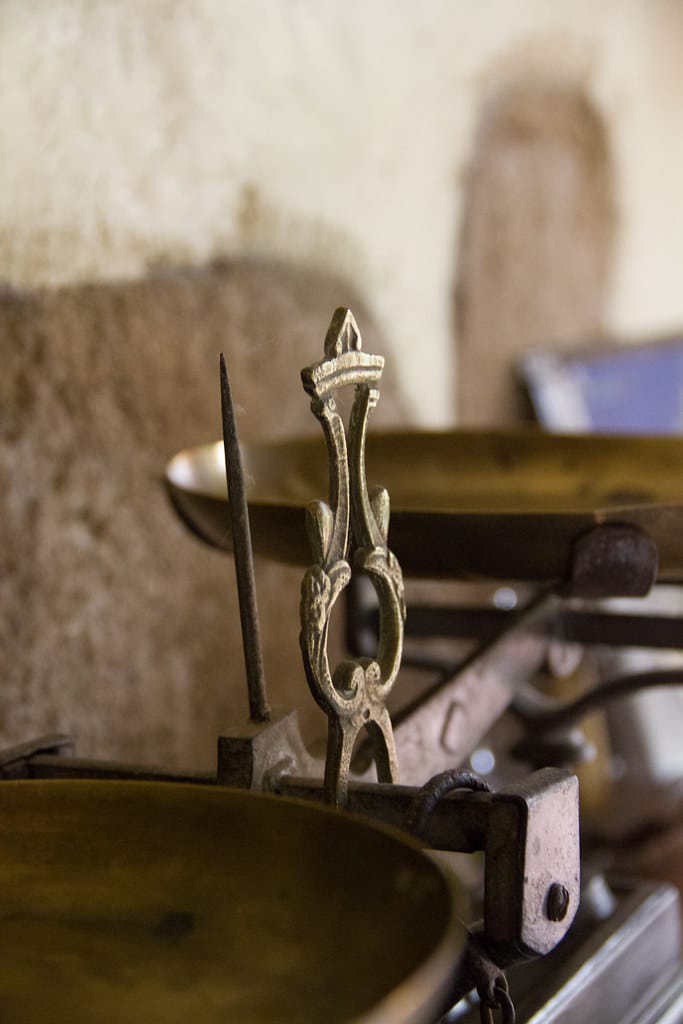 An antique balance scale — weighing the open vs closed model decision