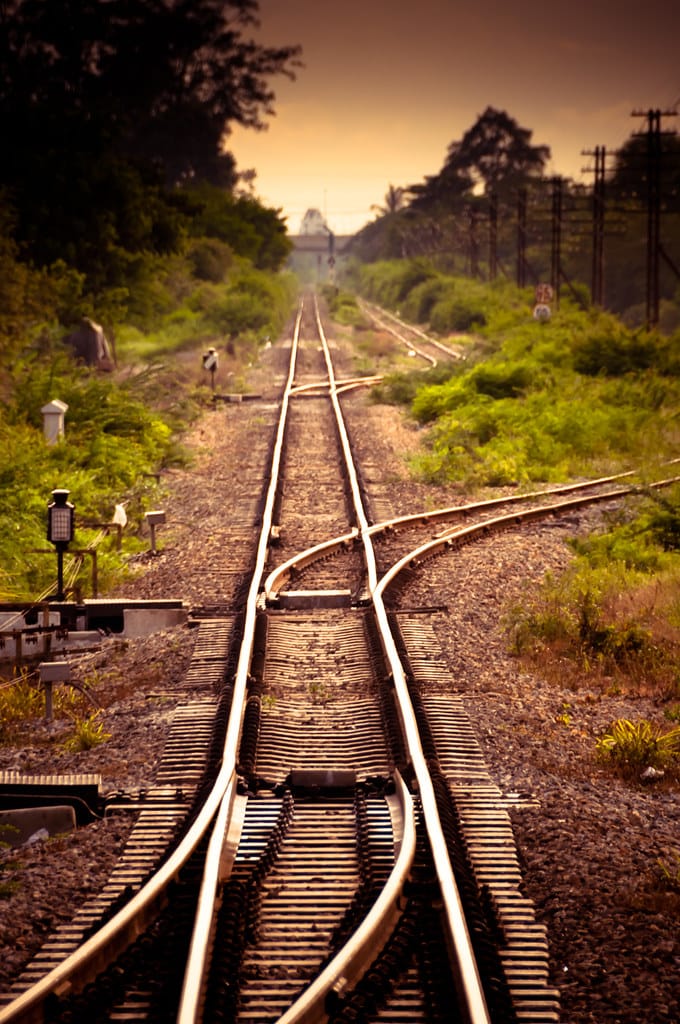 A railway switch where one set of tracks divides into two — choosing which path the train takes.